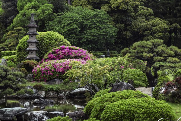 Pagoda nestled in a lush, blooming garden in Korakuen, Okayama, Okayama, Japan