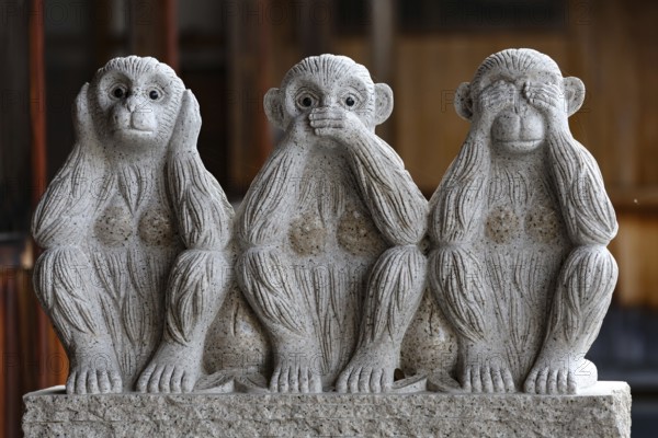 Stone sculpture of three monkeys in the temple in Yamanouchi, Yamanouchi, Japan