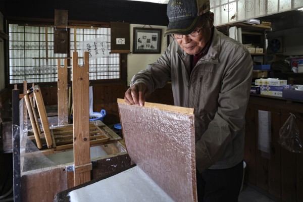 Papermaker working in a traditional workshop in Tsumago, Tsumago, Japan