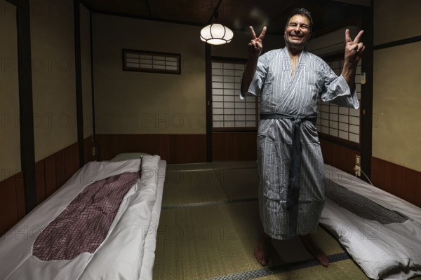Person in yukata in traditional Japanese room with tatami mats, Takayama, null, Japan