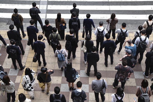 People gather at a busy pedestrian crossing, Osaka, Umeda, Japan
