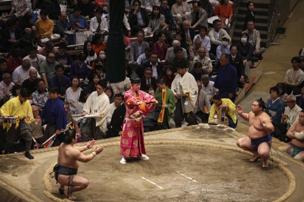 Sumo ritual in front of an enthusiastic audience in the hall, Tokyo, Japan