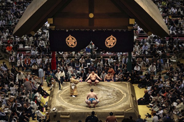 Sumo competition at Ryogoku Kokugikan Hall with concentrated audience, Tokyo, Japan