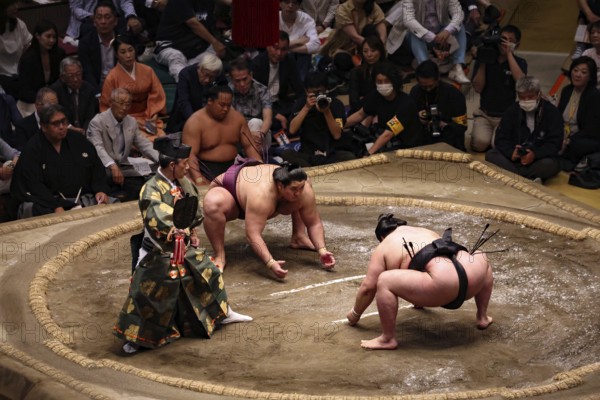 Start of a sumo fight in Kokugikan with an excited audience, Tokyo, Ryogoku, Japan