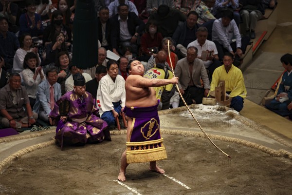 Sumo wrestler performs the ceremony with a bow swivel in Kokugikan, Tokyo, Ryogoku, Japan