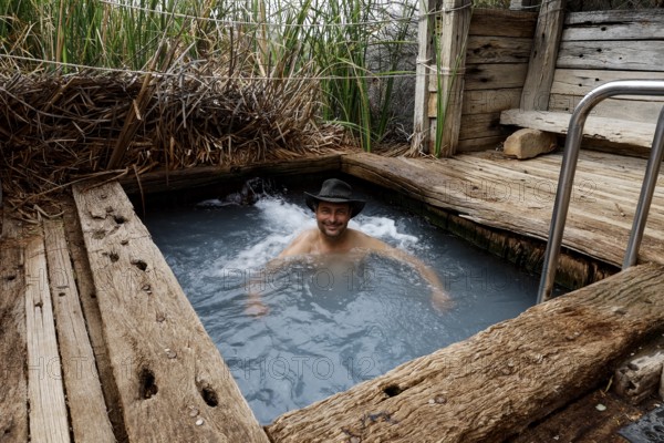 Person in a natural spring surrounded by wood in the outback, Oodnadatta Track, null, Australia