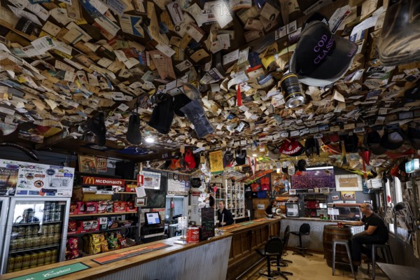 Rustic bar with colorful ceiling and wall decoration at William Creek Hotel, William Creek, South Australia, Australia