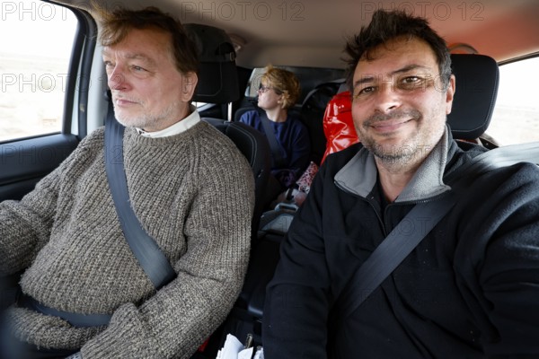 Interior view of a car on Oodnadatta Track with relaxed passengers