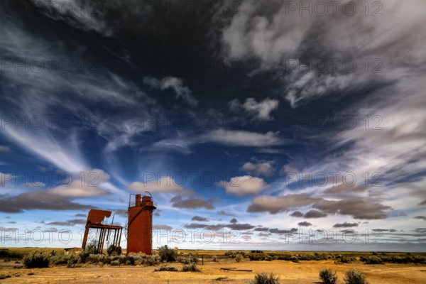 Abandoned water tower under dramatic sky on Oodnadatta Track, Curdimurka, South Australia, Australia