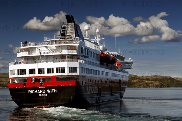 Hurtigruten ship moves picturesquely under blue sky on the sea, N Kirkenes, zero