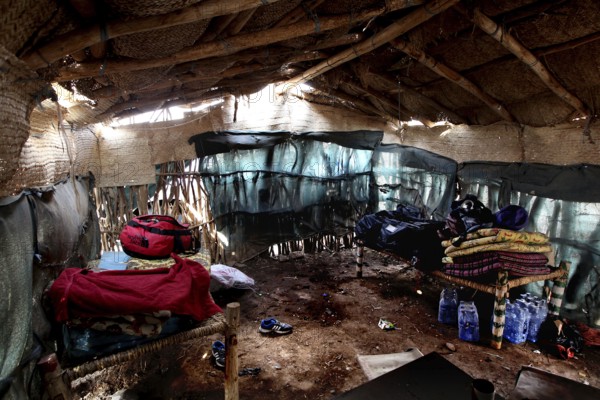 Interior view of rustic cabin with straw blankets and beds in Ahmedela, Ahmedela, Ethiopia