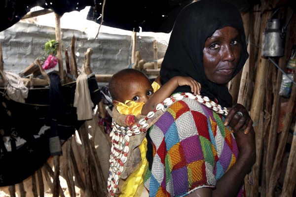 Muhammad's mother and Fatimeh in traditional clothes, the child on the back, Ahmedela, Tigray, Ethiopia