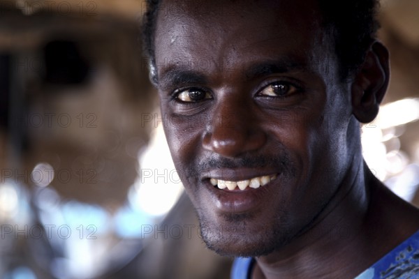 Muhammed is smiling in a close-up in his hut, Ahmedela, Tigray, Ethiopia