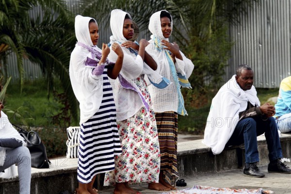 Women wearing religious clothing pray together in front of a church in Addis Ababa, Addis Ababa, Ethiopia