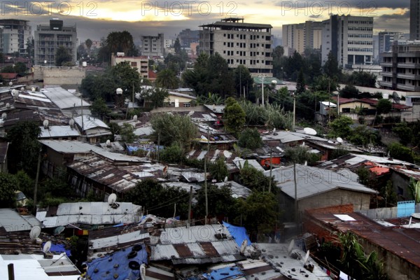 View of buildings and vegetation with dramatic evening sky, Addis Ababa, Ethiopia