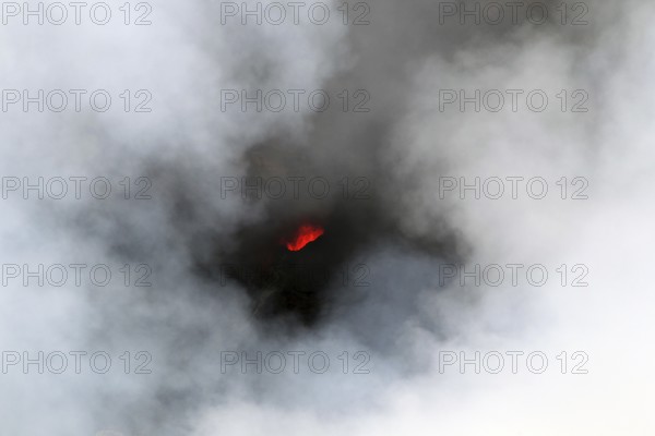 Smouldering volcano with a crater partly covered by haze, Erta Ale, Ethiopia