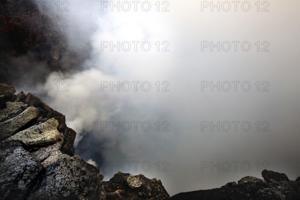Smoke rises from a volcanic crater and obscures the view, Erta Ale, Ethiopia