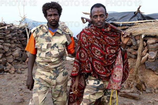 Two soldiers in traditional and military clothing at Erta Ale Camp, Erta Ale, Ethiopia