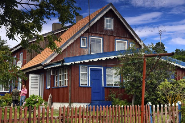 Traditional Lithuanian wooden house with colorful exterior and garden, Nida, Curonian Spit, Lithuania