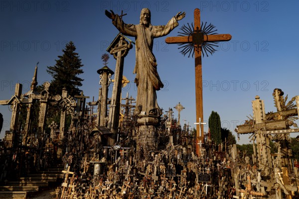 Hill of Crosses in Siauliai with countless crosses and religious symbols in the evening light, Siauliai, Lithuania