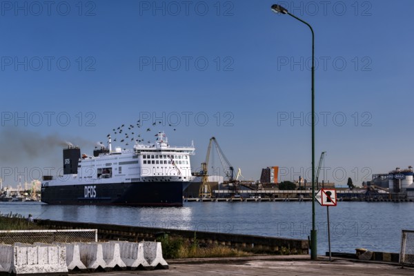 Ferry in the port of Sandkrug in the Curonian Lagoon surrounded by industrial structures, Sandkrug, Lithuania