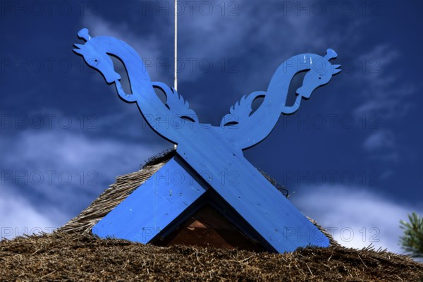 Blue wooden symbol on the pediment of the Thomas Mann House under a clear sky, Nida, Curonian Spit, Lithuania