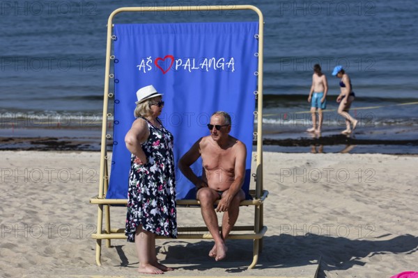 Two bathers on a sun chair on Palanga beach, children in water, Palanga, null, Lithuania
