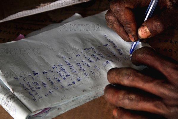 A person writes with a pen on paper in close-up, Mekele, Ethiopia