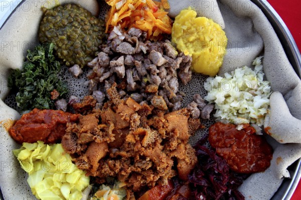 Diverse Ethiopian food platter with injera at Ben Abeba restaurant