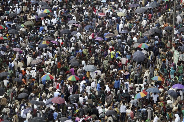 Dense crowd with colorful umbrellas at a busy market, Lalibela, Ethiopia