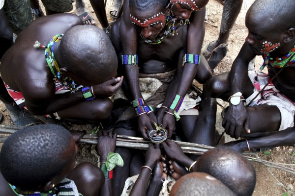 Group of Hamers gathers closely during a traditional initiation ritual, Turmi, null, Ethiopia