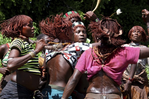 Dancing Hamer woman, united in dance celebration, in a ritual initiation session, Turmi, Ethiopia