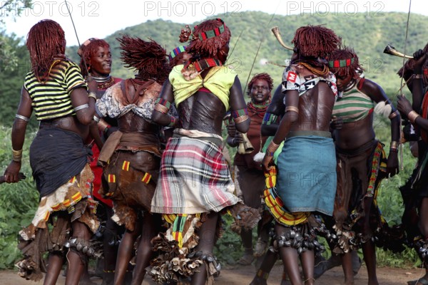 Hamer woman, wearing traditional clothes, dancing in circles, part of an initiation ritual, Turmi, Ethiopia