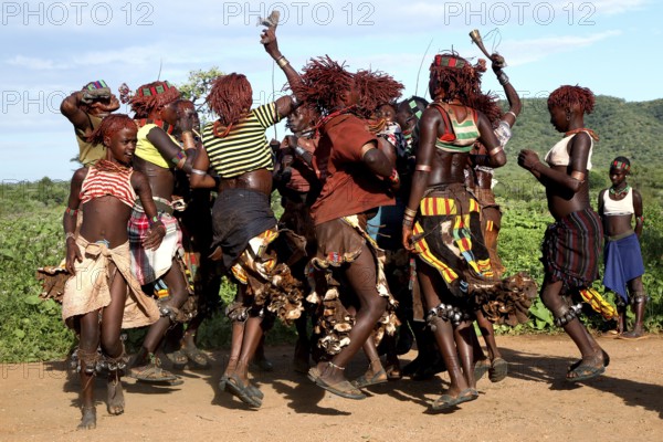 Hamer woman dance exuberantly and energetically as part of a traditional ceremony, Turmi, Ethiopia