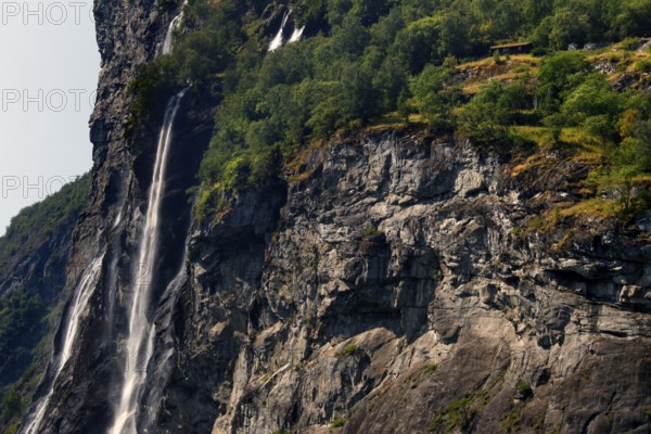 Fascinating rock wall with waterfall at Berghof in Geirangerfjord, Geirangerfjord, Møre og Romsdal, Norway