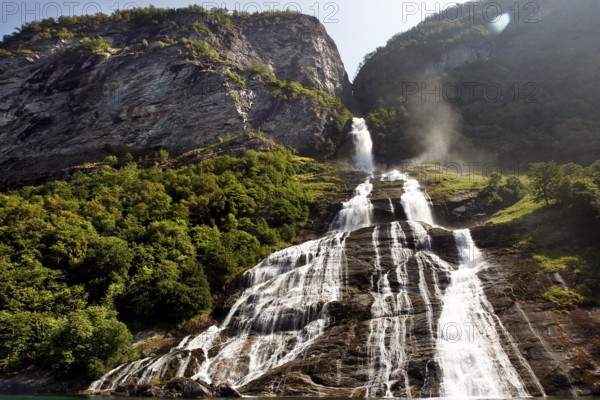Impressive waterfall in Geirangerfjord, flowing over green cliffs, Geirangerfjord, Møre og Romsdal, Norway