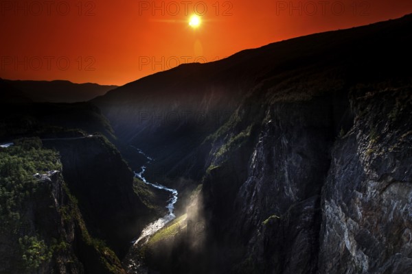 Spectacular view of Vøringsfossen at sunset in Måbødal, surrounded by dramatic rock faces, Eidfjord, Norway