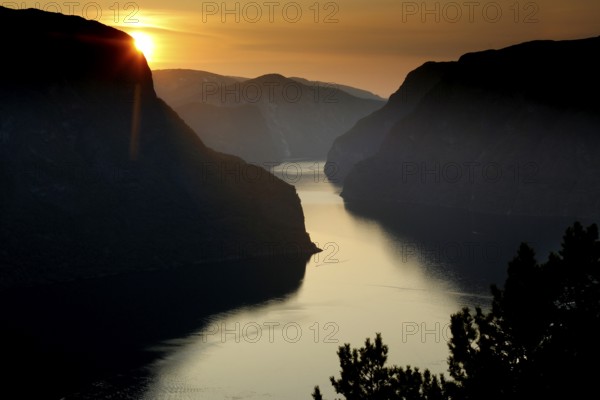 Sunset over Aurlandsfjord from Stegastein viewpoint with dramatic sky, Aurlandsvangen, Norway