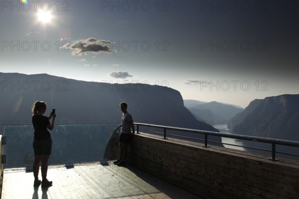 People enjoy the view of the fjord from the Stegastein platform, Aurlandsvangen, Norway