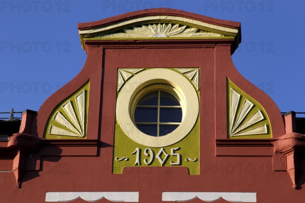 Detail of an Art Nouveau façade in Ålesund with round window opening and decorative ornaments, Ålesund, Møre og Romsdal, Norway