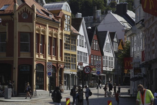 Scenic city view with historic colorful buildings and passers-by, Bergen, Hordaland, Norway