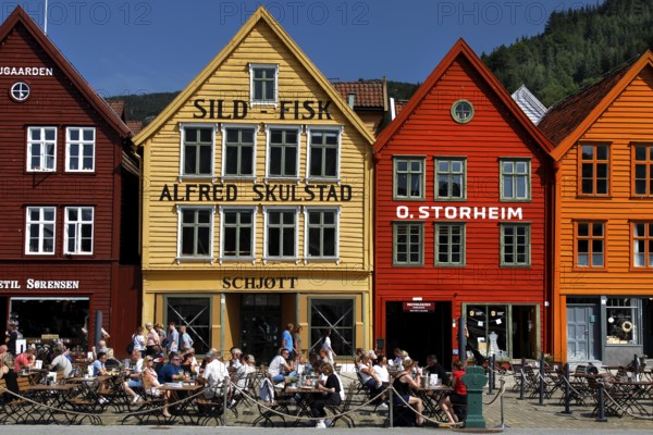 Cafes in front of the historic houses of Tyskebryggen in summer, Bergen, Norway