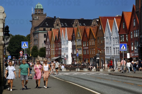 Summer scene of people strolling through Bergen Hanseatic Quarter, Bergen, Norway