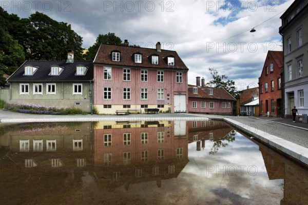 Historic wooden houses in Oslo reflected in a quiet water basin, Oslo, Damstredet, Norway