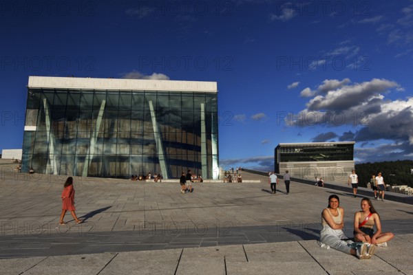 People enjoy sunny day in front of Oslo Opera and Munch Museum, Oslo, Bjøvika, Norway