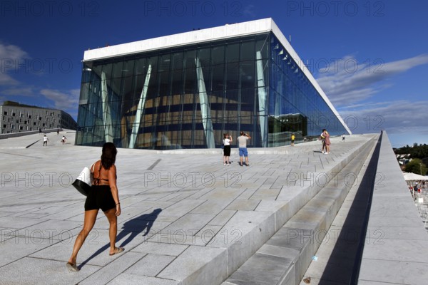 Visitors walk up the steps to the modern Oslo Opera, Oslo, Bjøvika, Norway