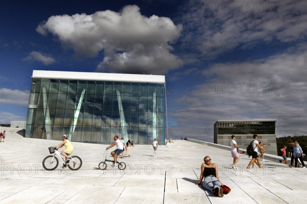 Cyclists and pedestrians on the white surface of Oslo Opera, Oslo, Bjøvika, Norway