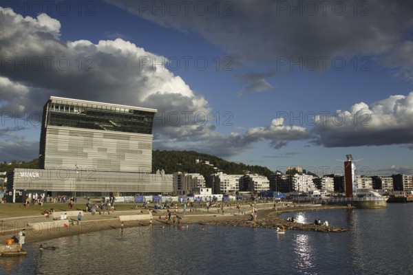 Modern building on the beach with dramatic clouds in the sky, Oslo, Norway
