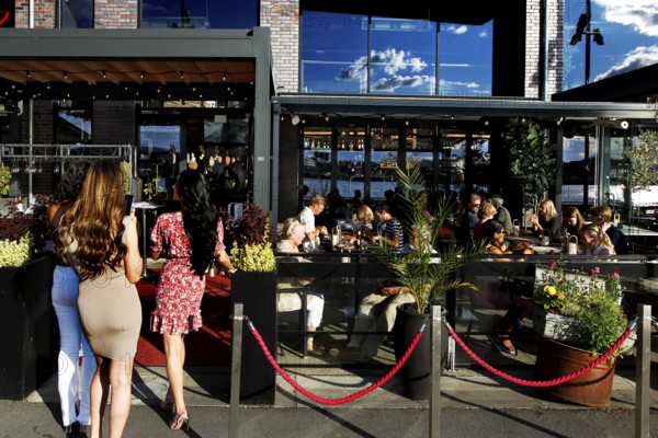 Restaurant guests sit outdoors in sunny weather in Sørengkaia, Oslo, Oslo, Bispevika, Norway