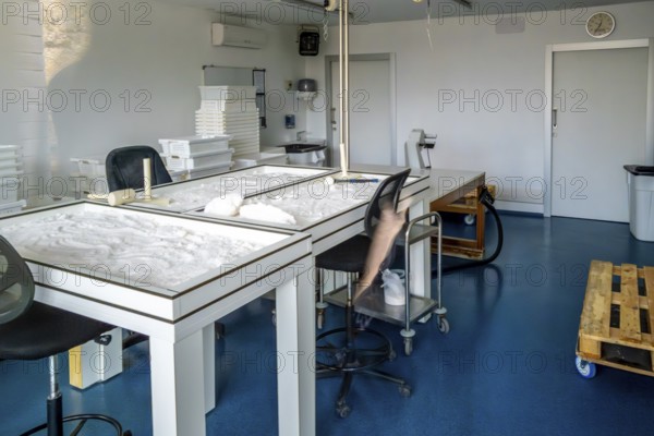 Interior view of the anana salt flats laboratory showing tables with natural salt drying process, emphasizing traditional salt production and mineral extraction from the valley